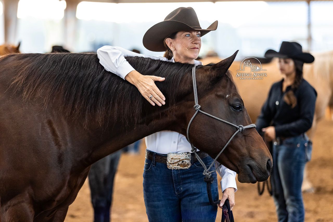 An exhibitor sharing a quiet moment with a horse at the show